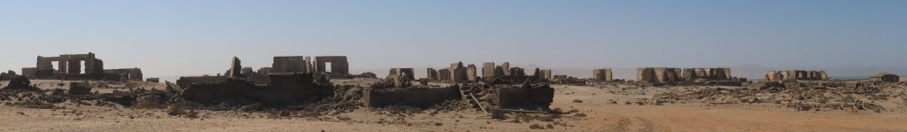 Wide image of many abandoned and decaying buildings in Elizabeth Bay Namibia