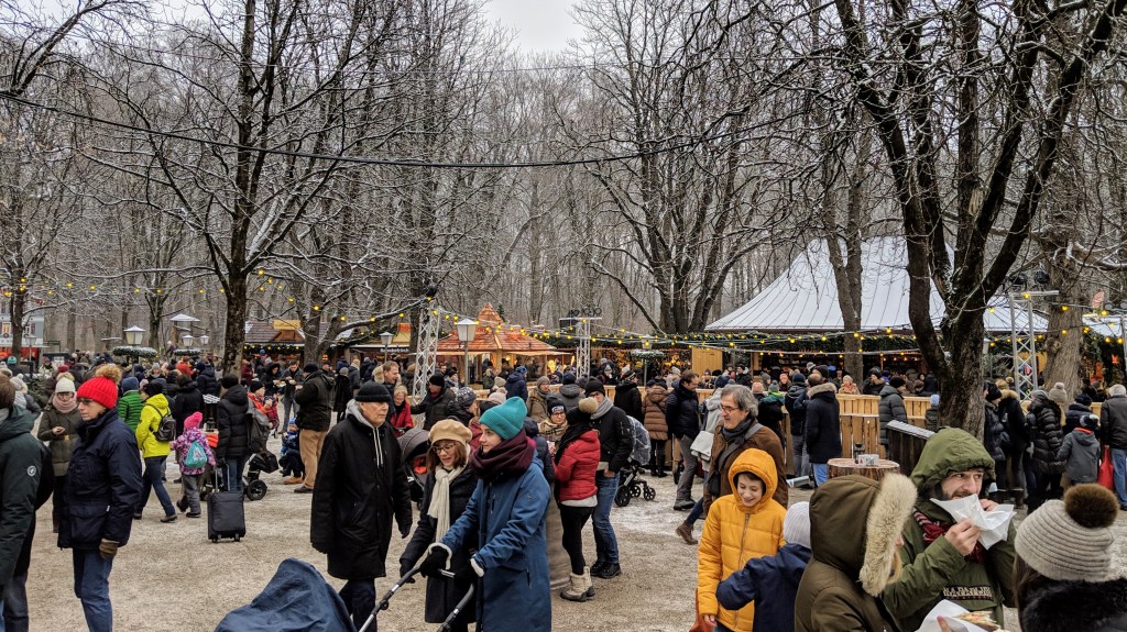 Crowds of people in the Chinese Tower Christmas market at the English Garden in Munich